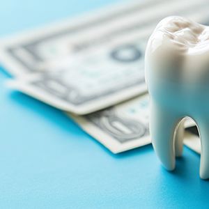 Fake tooth and pile of money